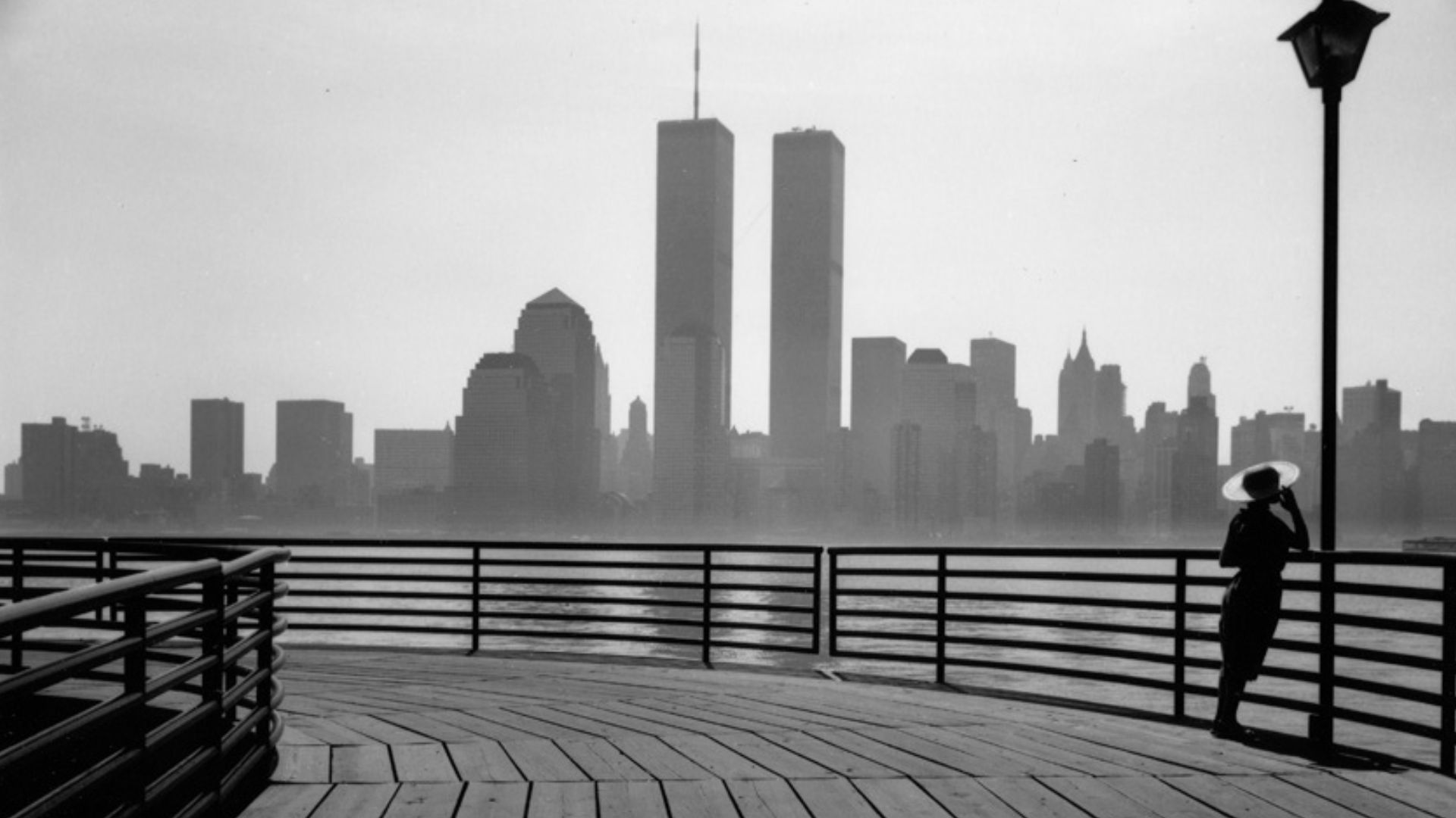 Black and white image of the Twin Towers as seen from across the river on a cloudy day