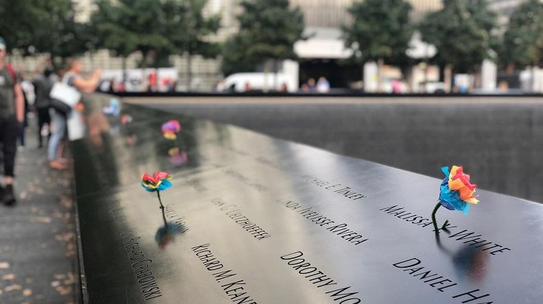 Image of Memorial parapet with colorful paper flowers