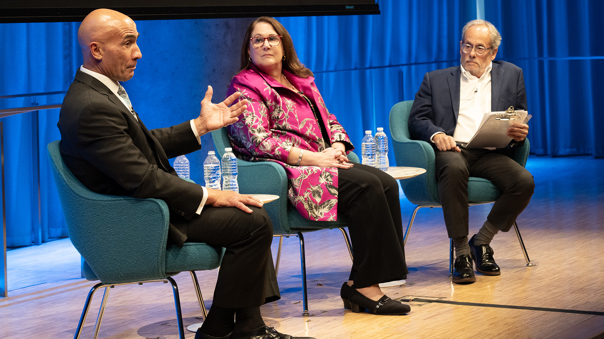 From left: John Liguori talking to Mary E. Galligan and Clifford Chanin on stage