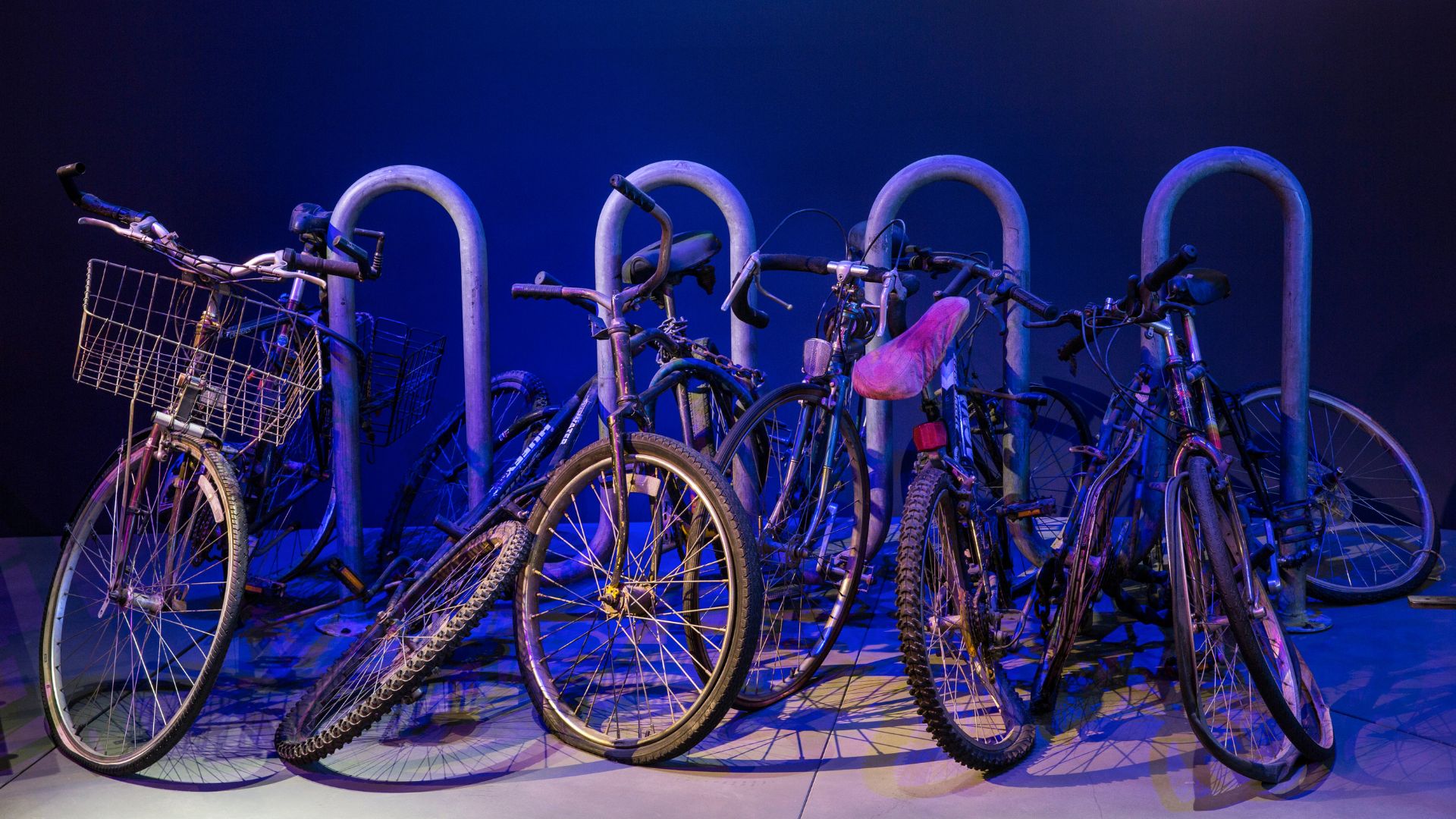 A display of bicycles positioned against a metal bike rack