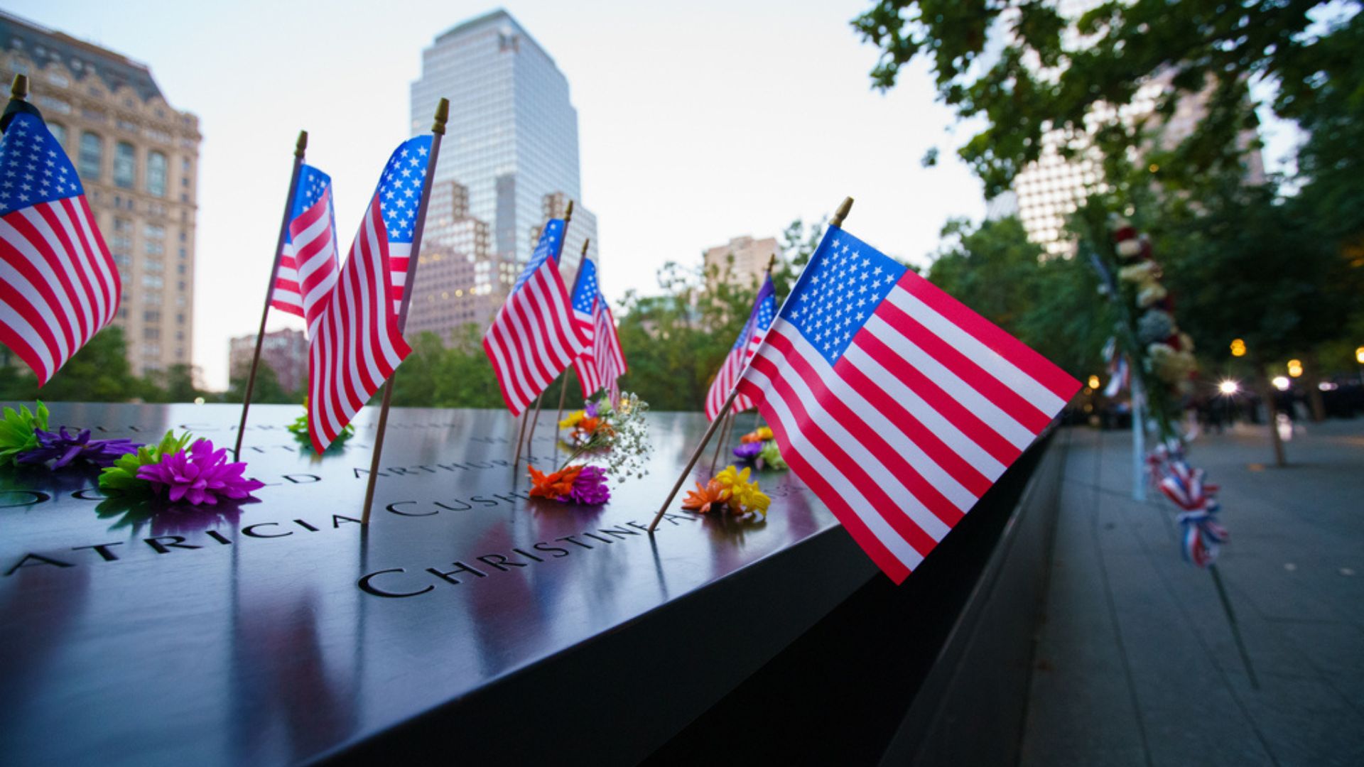 Small American flags and flowers on Memorial parapet