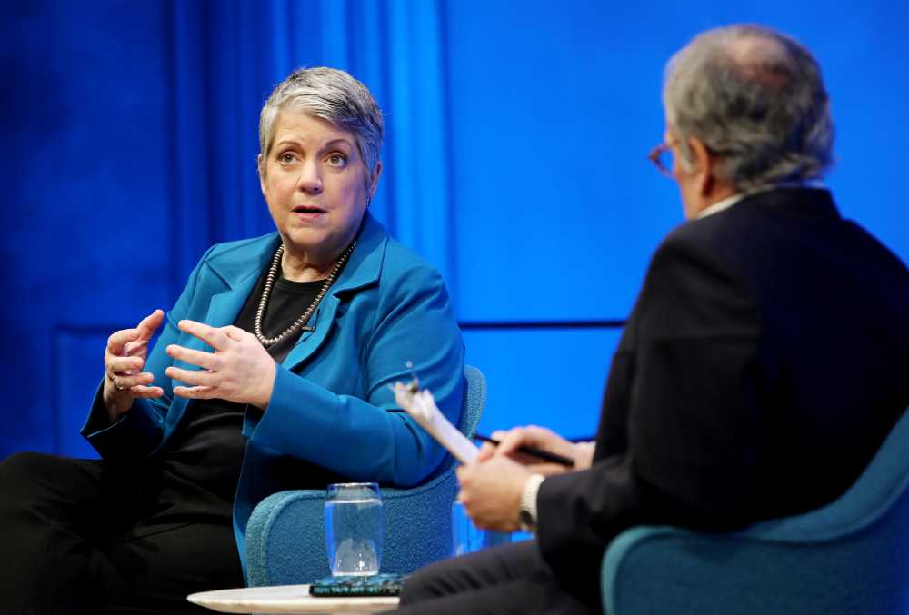 Former Secretary of the Department of Homeland Security Janet Napolitano gestures onstage as she takes part in the public program, How Safe Are We? Homeland Security Since 9/11. She is seated next to Clifford Chanin, the executive vice president and deputy director for museum programs, who is holding a clipboard and listening to her speak.