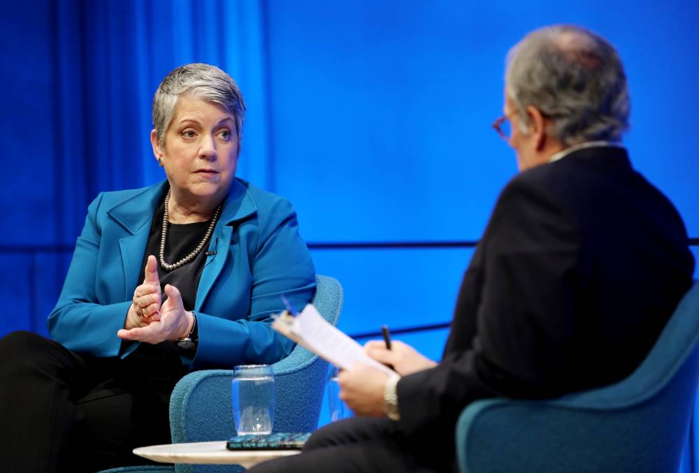 Former Secretary of the Department of Homeland Security Janet Napolitano makes a chopping motion with her hand as she speaks with Clifford Chanin, the executive vice president and deputy director for museum programs, during a public program at the Museum Auditorium. Chanin is seated in the foreground and slightly out of focus.