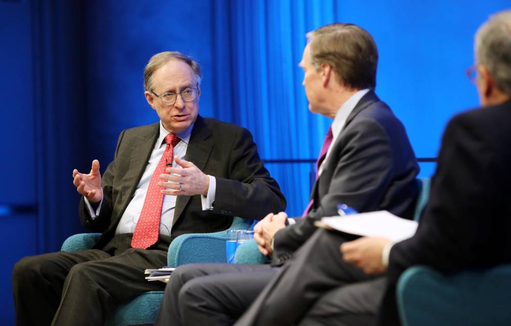 Former Deputy Secretary General of NATO Alexander Vershbow gestures with both hands as he speaks onstage at the Museum Auditorium. He is sitting beside former Deputy Secretary General of NATO Alexander Vershbow. Clifford Chanin, the executive vice president and deputy director for museum programs, is seen holding a clipboard in the foreground and is slightly out of focus.