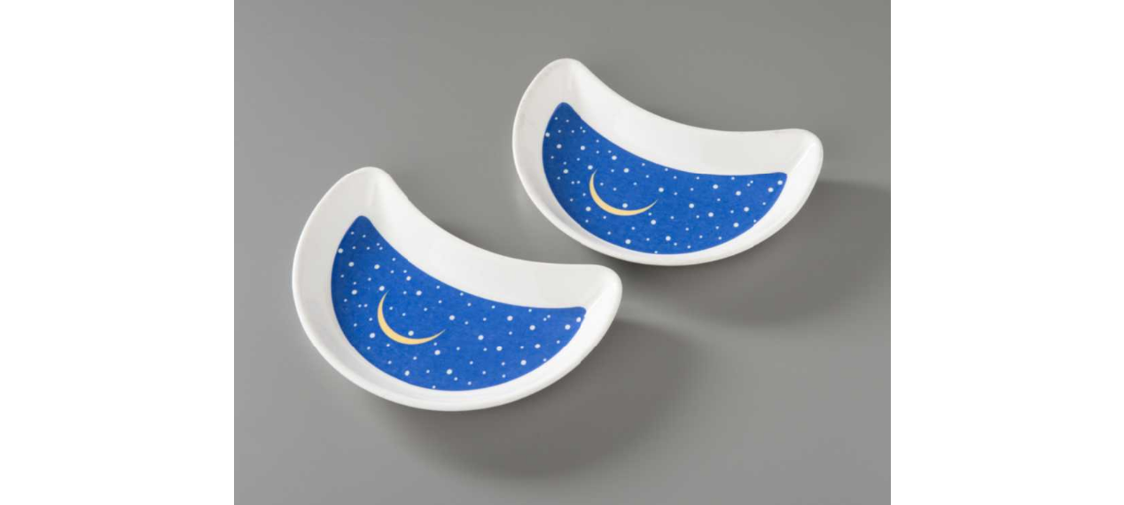 Crescent-shaped bread-and-butter plate used at Windows on the World restaurant. The face of the plate is blue with white stars and a yellow sliver moon.