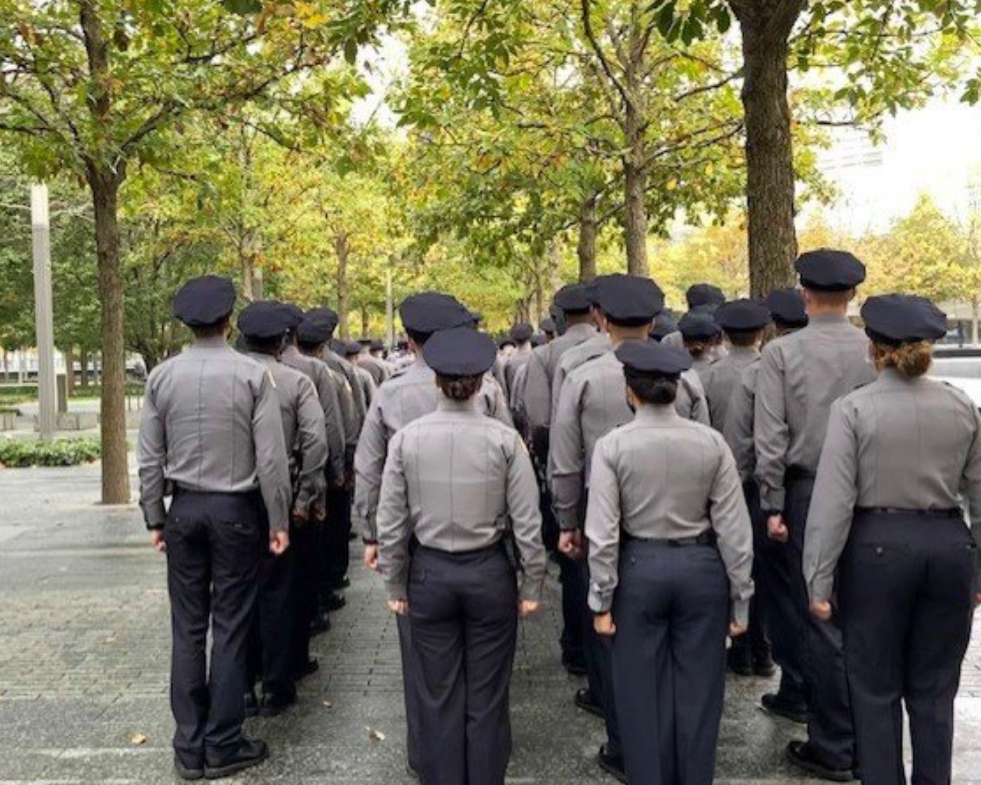 Back view of NYPD recruits gathered at the Memorial 