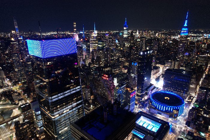 Midtown Manhattan skyline with iconic buildings lit in blue