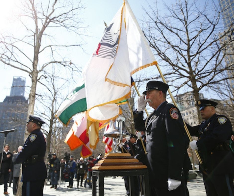 Uniformed members of the FDNY, NYPD, and PAPD stand at attention during the ceremony