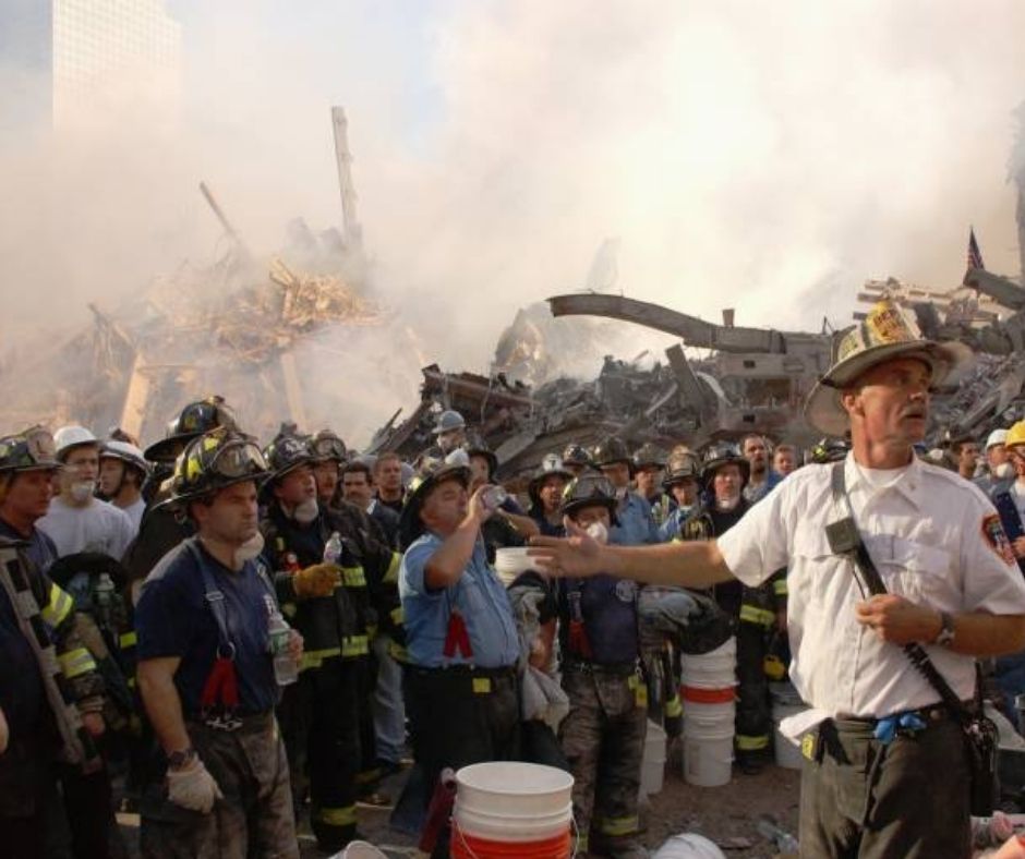 A group of rescue and recovery workers stand along the pile at Ground Zero