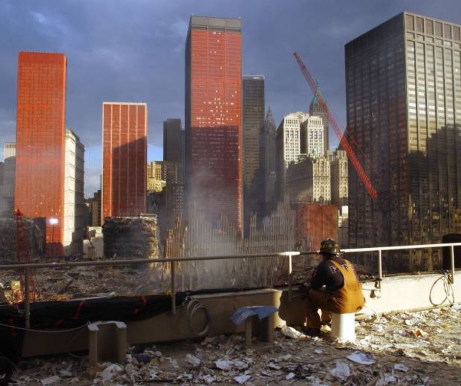 Back view of a rescue and recovery worker looking out at the ruins of Ground Zero