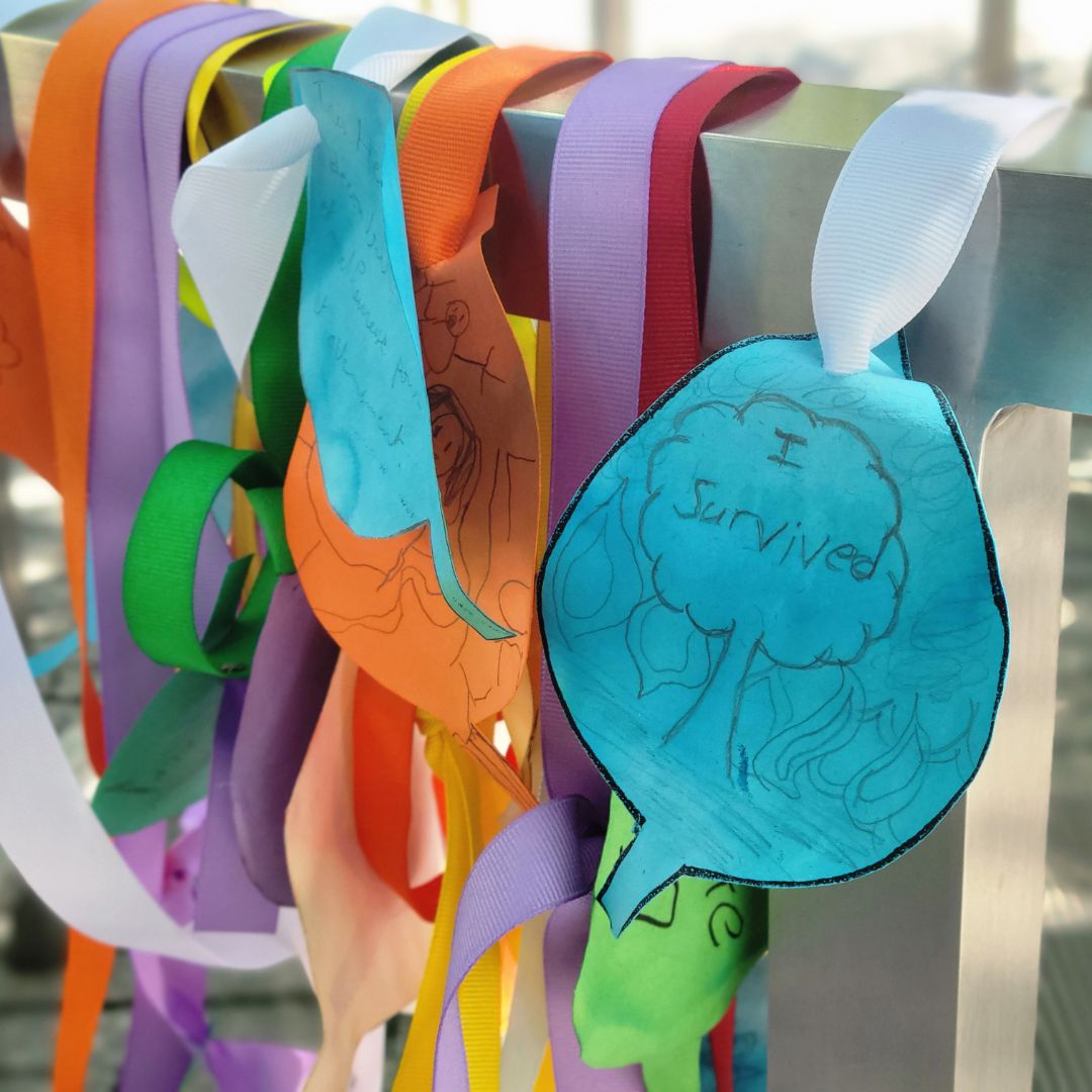 Colorful messages and notes adorning the Survivor Tree