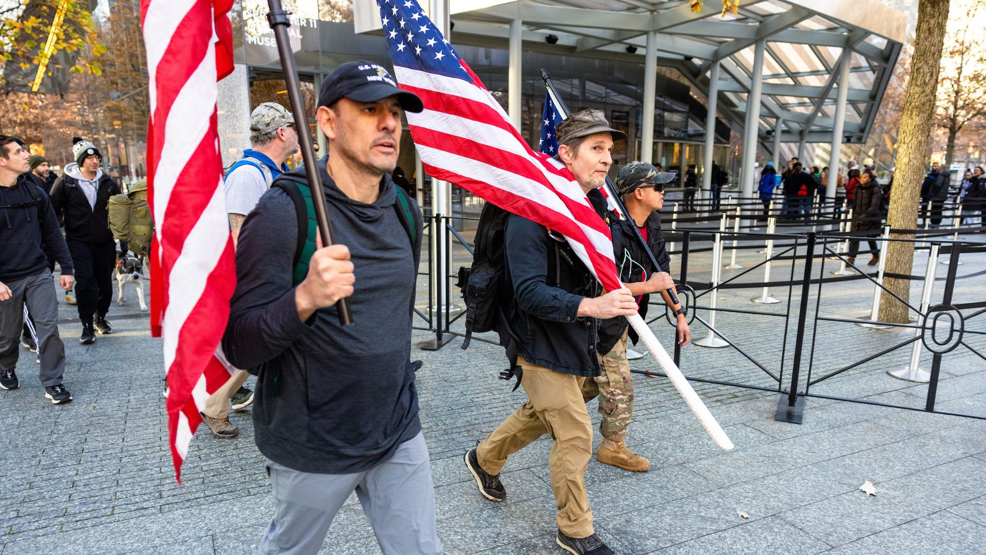 Ruck participants carry American flags onto the Plaza