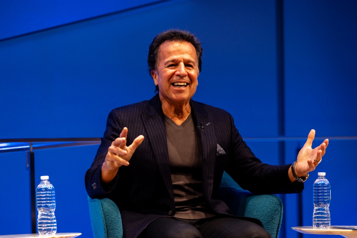 Man gestures and smiles