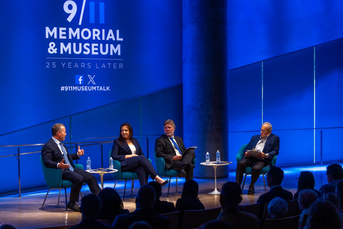 Four people sit on stage, having a conversation 