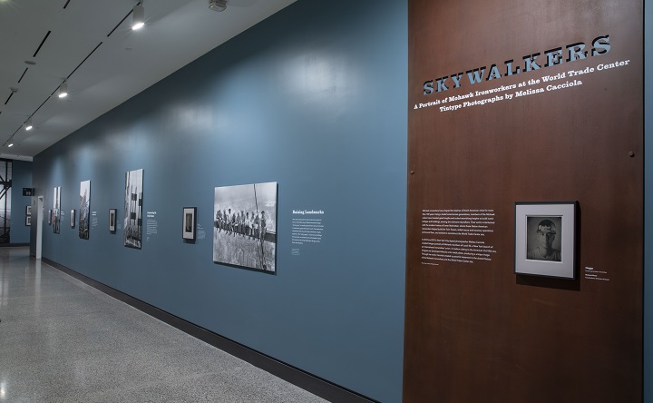 Photos in the Skywalkers exhibition are displayed on a wall in the Museum. 