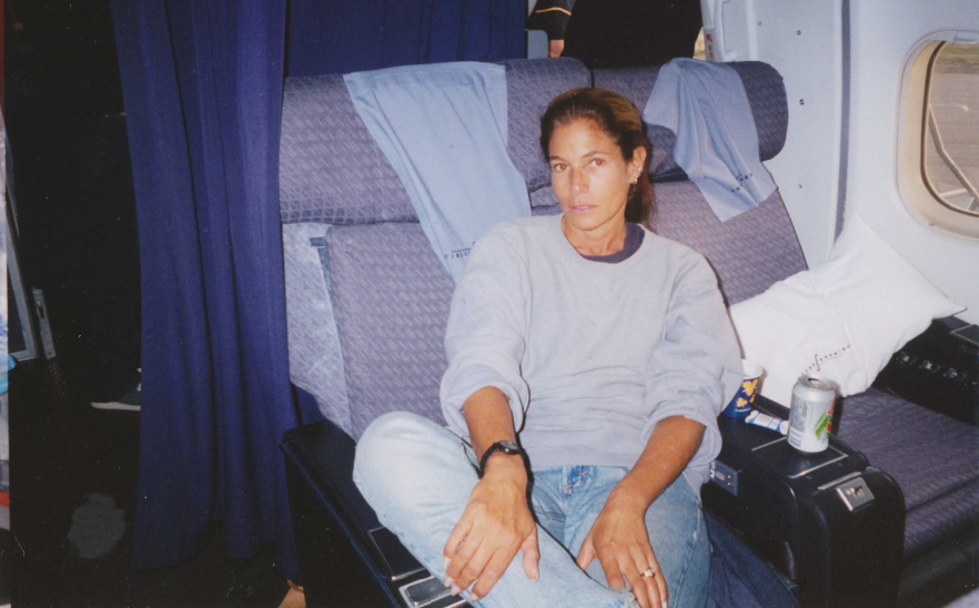 Photograph of Jackie Pinto sitting inside the cabin of the grounded airliner. 