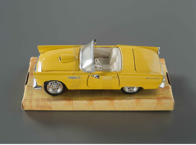 A model of a yellow convertible car 