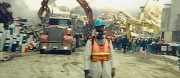John Paluska at Ground Zero, in gas mask, neon safety vest, and hard hat 