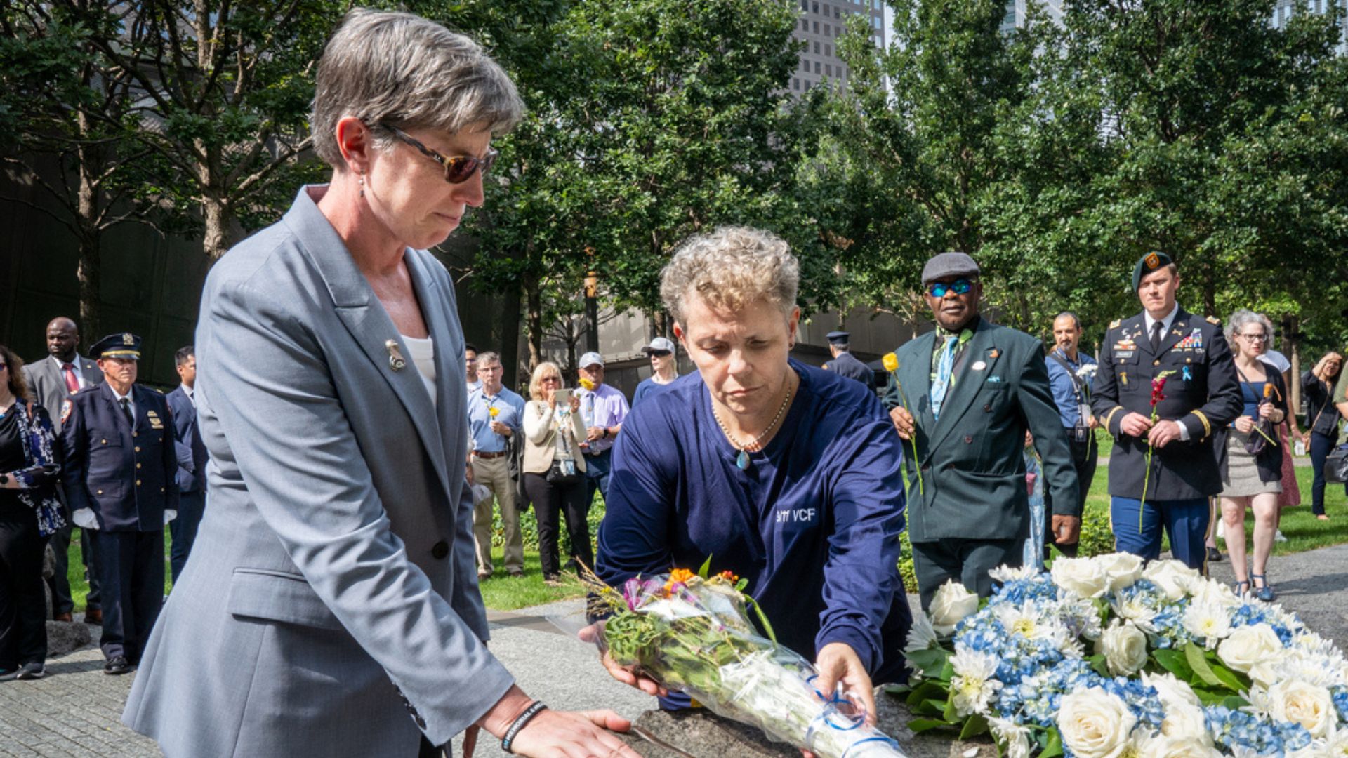 Beth Hillman and Allison Turkel lay flowers on the Memorial Glade 