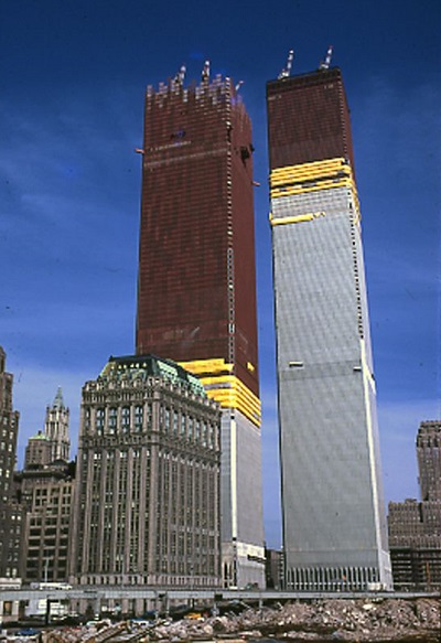 Twin Towers under different stages of construction. The tower on the left has about a third of its steel structures cladded in aluminum. Four-fifth of the tower on the right is cladded with aluminum.