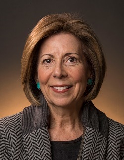 Portrait of Alice Greenwald, a woman with chin-length light brown hair wearing a dark top under a dark gray jacket