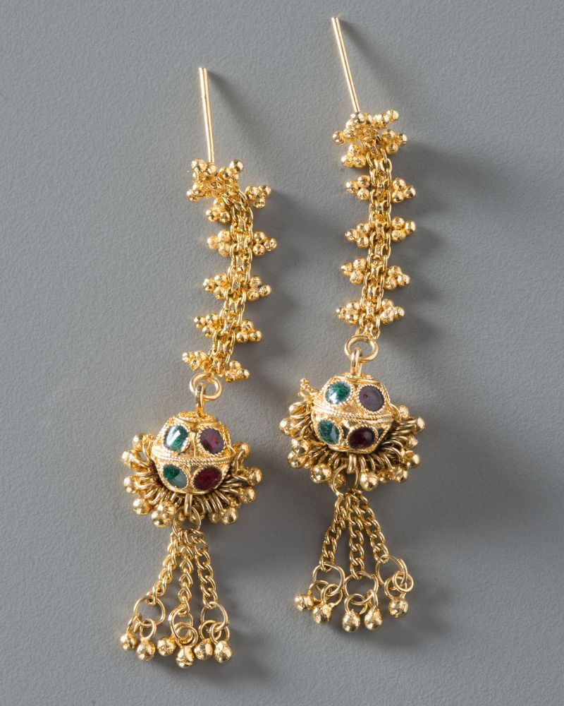 Gold earrings with intricate detailing and small colored gems.