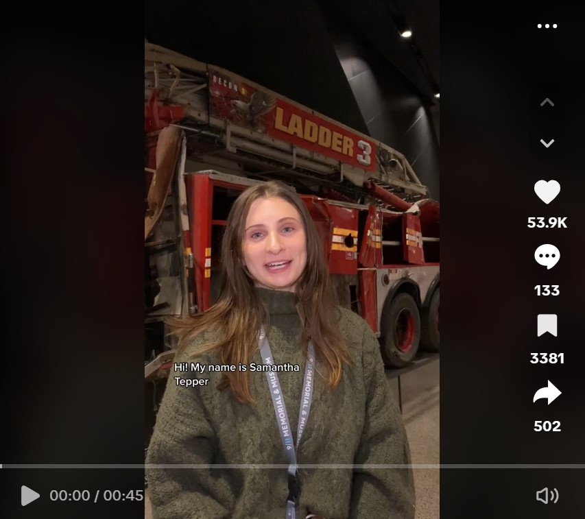 Samantha stands in front of a Ladder Truck for a TikTok