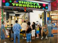 Oil painting of a boardwalk shooting stand from Seaside Heights, NJ called "Shoot the Terrorist," which featured a large photo of binLaden, beer funnels and neon paint ball splatters during the summer of 2009. 