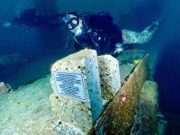 This is a photo of a Navy Seal right after the BLUE FREEDOM DUO of sculptures were permanently adhered to the deck of the US Vandenberg sunken ship now as an artificial reef.