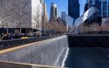 The Memorial pools are shown with water flowing on a sunny day. The Oculus is visible in the background.