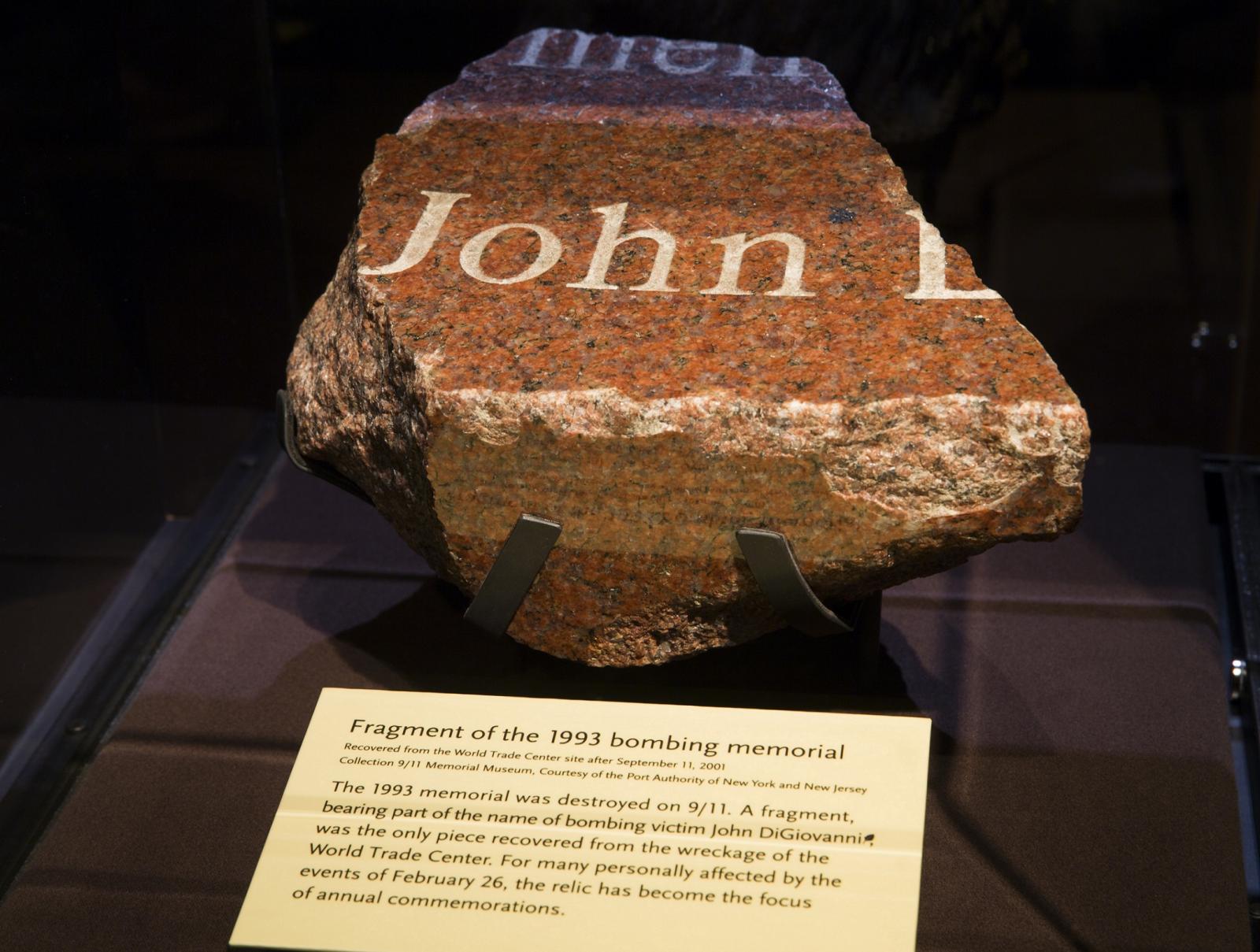 A fragment from the original memorial to the victims of the February 26, 1993 bombing is displayed at the Museum. The name “John” can clearly be read on the piece of red, black, and white granite. A Museum placard below the fragment explains its historical significance.