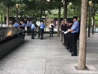 Probationary officers in blue line the Memorial Plaza.