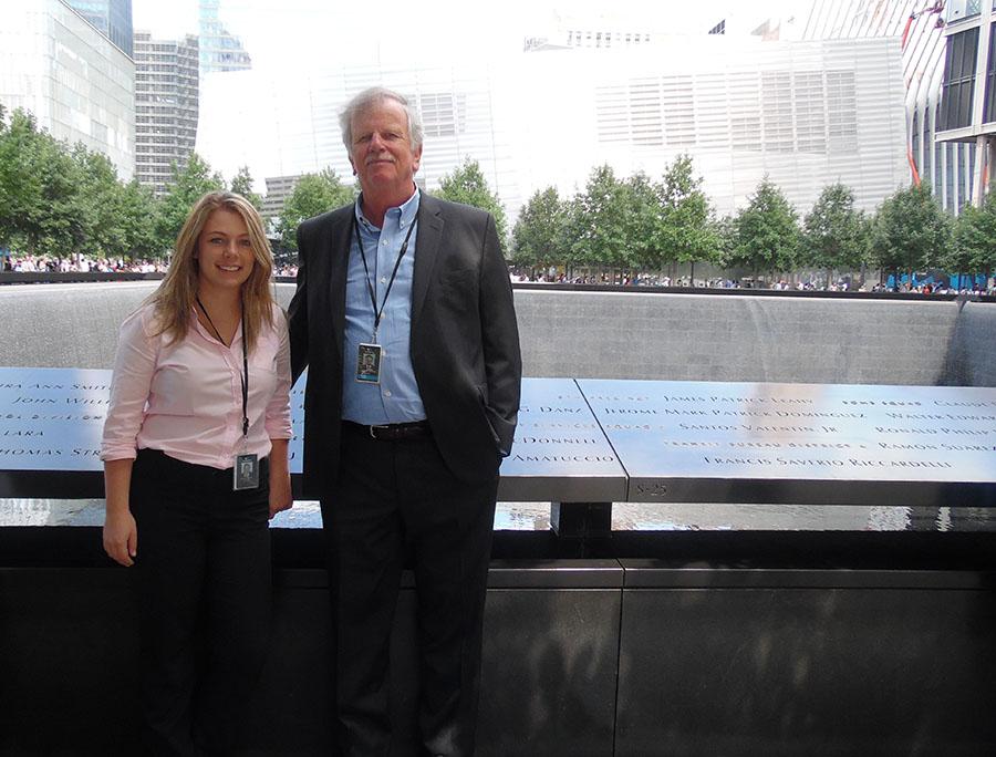 Georgia Bender and Larry Mannion, vice president of security, fire and life safety, stand beside the south pool on the 9/11 Memorial.