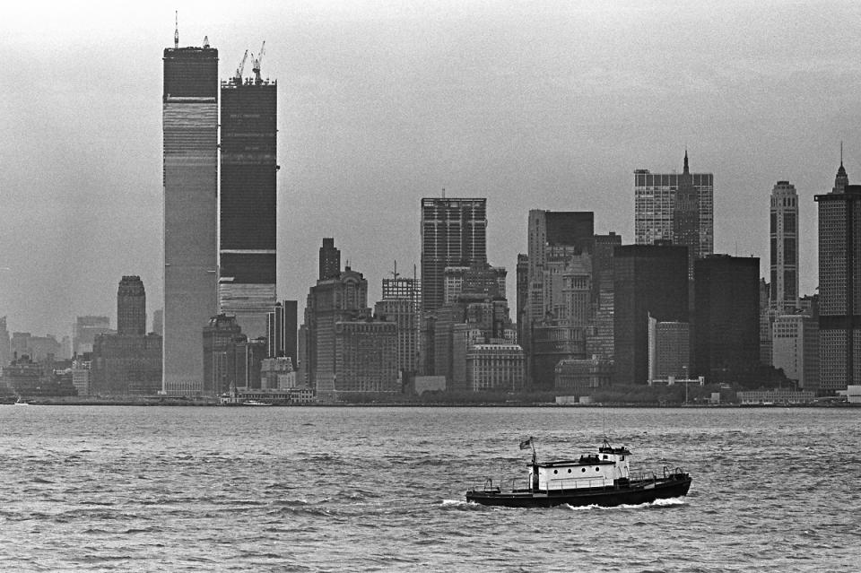 The Twin Towers are seen under construction in this black-and-white photo taken from New York Harbor in the 1970s.