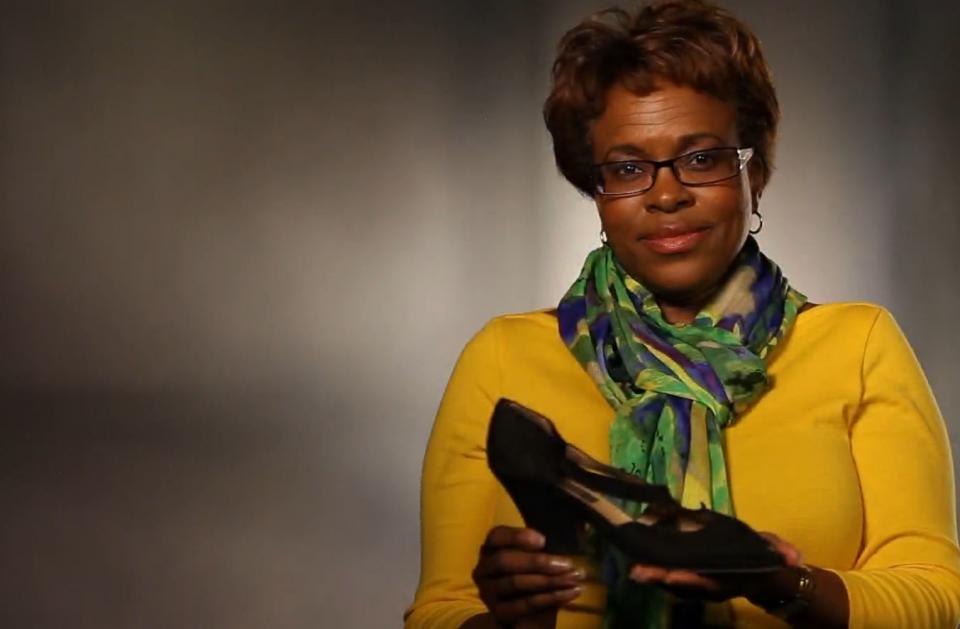 9/11 survivor Florence Jones holds up the shoes she wore on 9/11.