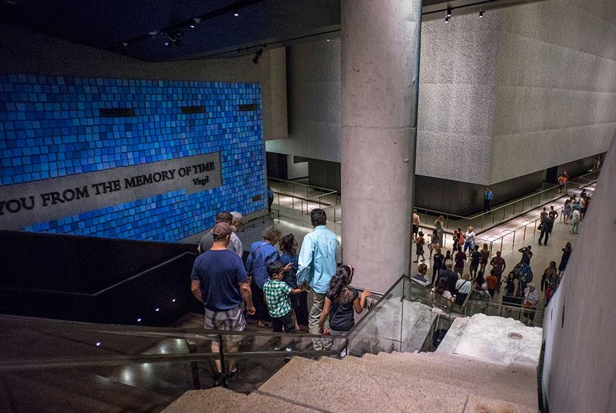Visitors descend to bedrock at the Museum. To their right is the Survivors’ Staircase. To the left is artist Spencer Finch’s installation, “Trying to Remember the Color of the Sky on That September Morning.”