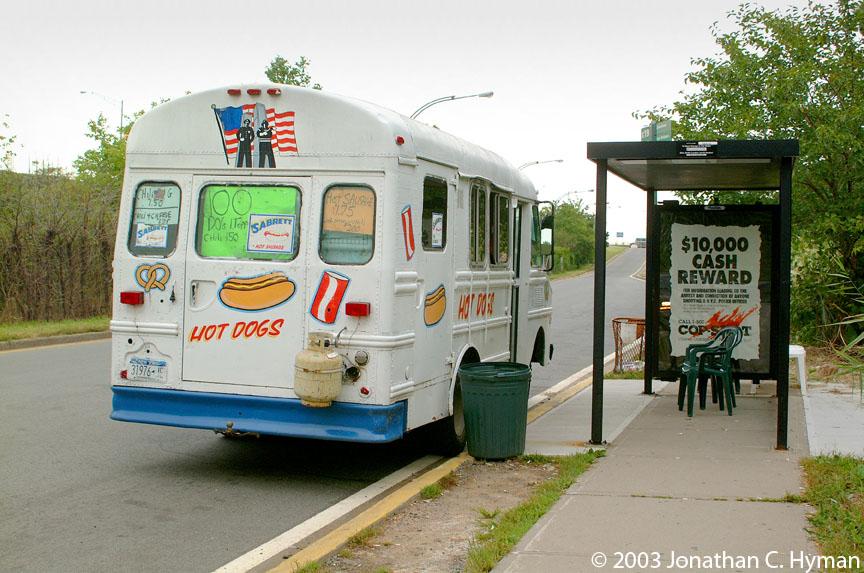Johnny Perna’s hot dog truck sits at a bus stop on Staten Island in 2003. The truck features a decal of an American flag and the Twin Towers.