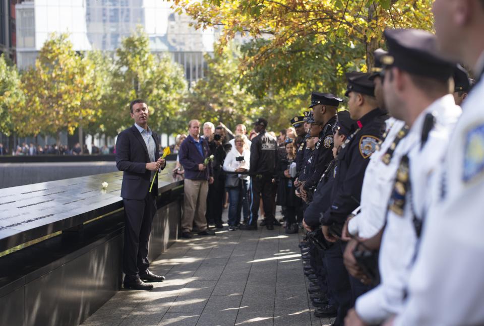 9/11 Memorial President Joe Daniels addresses dozens of NYPD officers beside a reflecting pool on Memorial plaza.