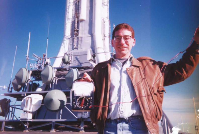 Donald DiFranco poses for a photo near the Channel 7 satellites on top of the North Tower.