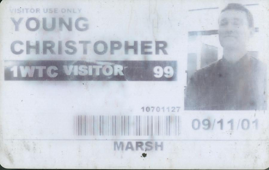 A temporary World Trade Center ID badge belonging to trapped survivor Christopher Briggs Young is displayed. It features a black-and-white photo of Young and his name, as well as the date September 11, 2001.