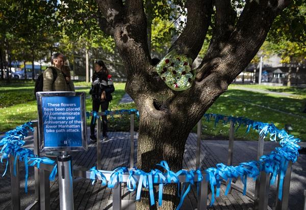 Blue commemorative ribbons ring a railing around the survivor tree in tribute to the victims of the 2017 bike path attack in lower Manhattan.