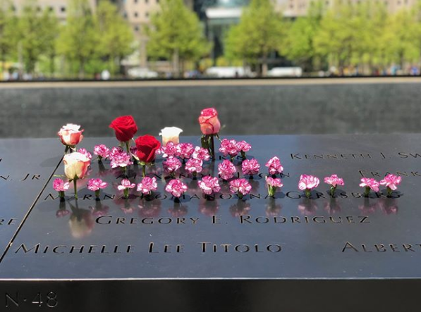 Red and white roses and other flowers have been placed at the names of Vladimir Savinkin, Alexander Lygin, and Marina Romanovna Gertsberg on the 9/11 Memorial.