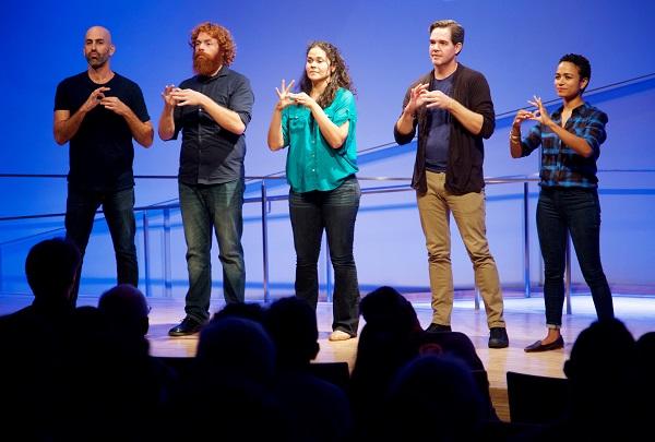 Three men and two women gesture onstage during the ASL Slam at the Museum auditorium.
