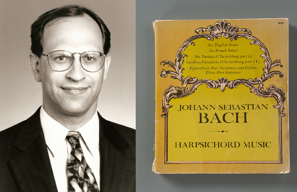 Michael Packer smiles in a suit and tie in a black and white portrait photo. A yellow-colored book of harpsichord music by composer Johann Sebastian Bach is displayed on a gray surface. Packer was a lifelong musician and also an industry leader in finance. He was in the North Tower on 9/11.