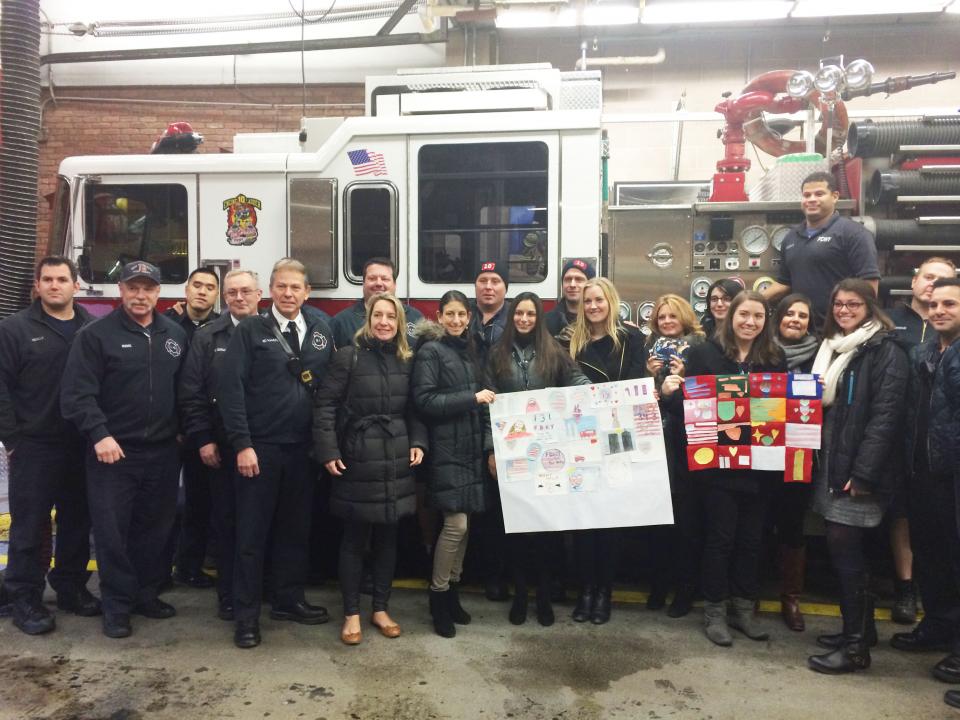 9/11 Memorial staff pose for a photo with members of FDNY Engine 10/Ladder 10 while delivering “Dear Hero” cards.