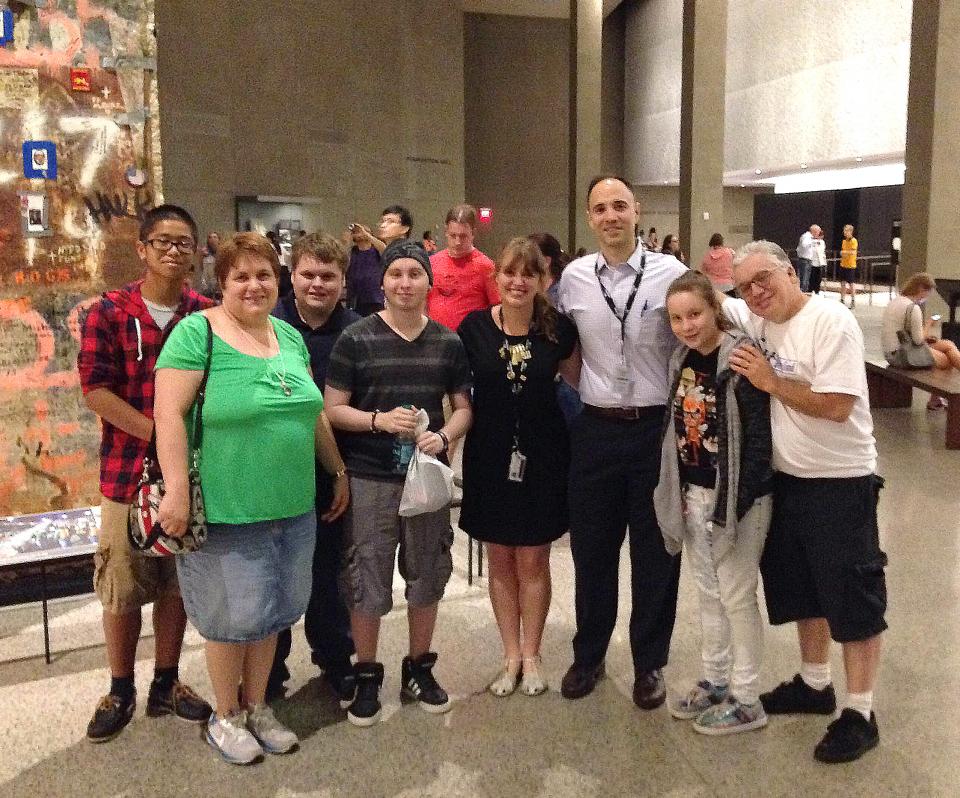 Michael Varisco, a teenager with a life-threatening illness, and his family members stand by the Last Column during their visit to the 9/11 Memorial Museum.
