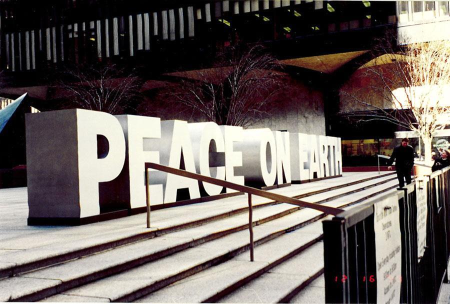 A large sign that says "Peace on Earth" has been set up on the plaza between the Twin Towers.