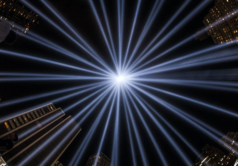 The individual beams compromising the Tribute in Light soar into the sky of lower Manhattan on a cloudless night.