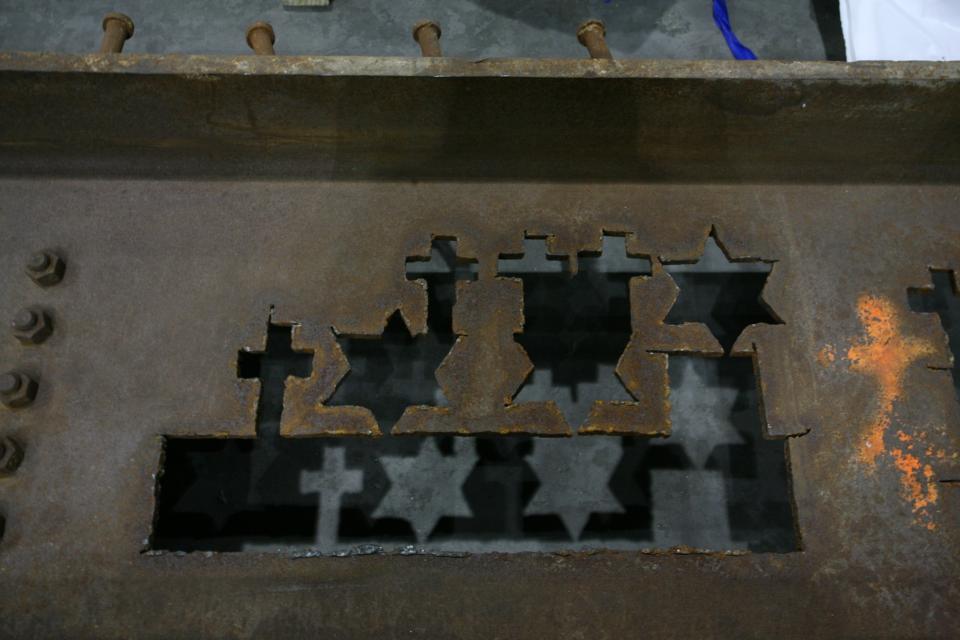 Crosses and Stars of David are seen forged in World Trade Center steel.
