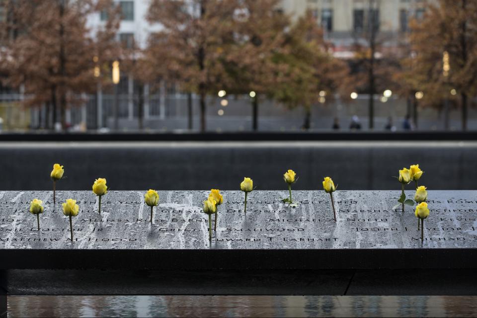 About a dozen yellow roses have been placed at the names of victims on the 9/11 Memorial on Veterans Day.